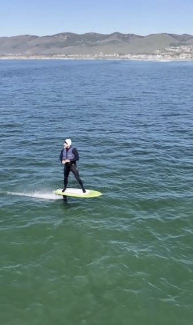 Mike Mills up on foil off the Central Coast, board clear of the water